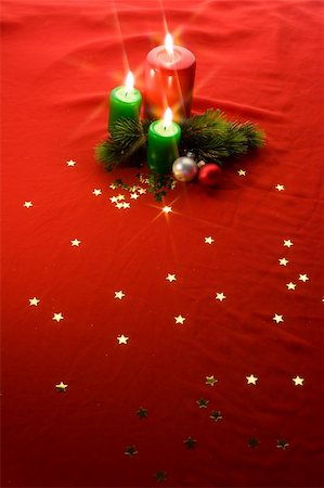 Burning xmas candle, little gift box and golden hand bells. Christmas decorations of the cross filter effect Stock Photo - Budget Royalty-Free & Subscription, Code: 400-05187319