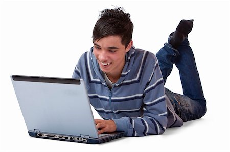 Young teenager is lying on floor and surfing on his laptop Stock Photo - Budget Royalty-Free & Subscription, Code: 400-05187588