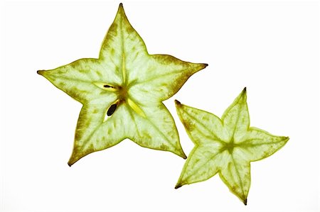 sliced carambola - Sliced Carambola Starfruit isolated on white studio shot Photographie de stock - Aubaine LD & Abonnement, Code: 400-05188304