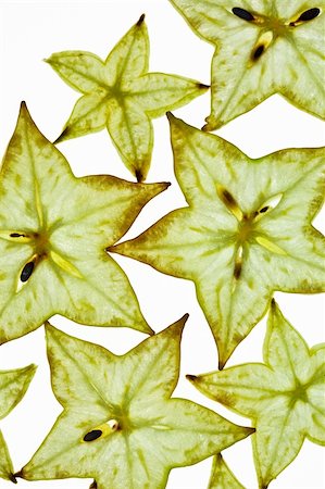 sliced carambola - Sliced Carambola Starfruit isolated on white studio shot Photographie de stock - Aubaine LD & Abonnement, Code: 400-05188303