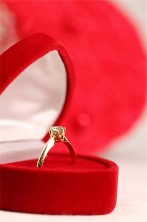 simsearch:400-06075507,k - Golden engagement ring in a heart shaped box on red background. Shallow DOF Stock Photo - Budget Royalty-Free & Subscription, Code: 400-05188426