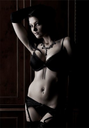 simsearch:400-04147825,k - Sexy young adult caucasian woman in black lingerie with high contrast lighting Fotografie stock - Microstock e Abbonamento, Codice: 400-05188611