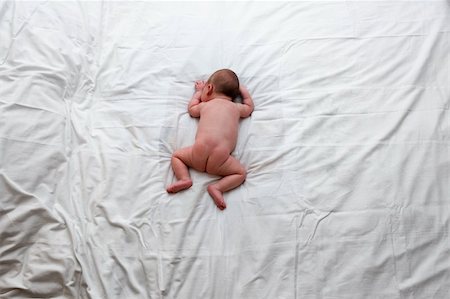 simsearch:632-05553588,k - Seeping alone. Little baby lying on the bed Stock Photo - Budget Royalty-Free & Subscription, Code: 400-05180039