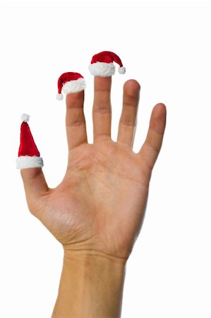 simsearch:400-04657079,k - Isolated hand holding up santa's red hats on fingers Fotografie stock - Microstock e Abbonamento, Codice: 400-05180067