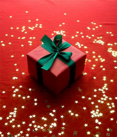simsearch:400-06070265,k - Close-up xmas gift over golden stars background Stock Photo - Budget Royalty-Free & Subscription, Code: 400-05180091