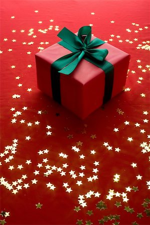 simsearch:400-06070265,k - Close-up xmas gift over golden stars background Stock Photo - Budget Royalty-Free & Subscription, Code: 400-05180092