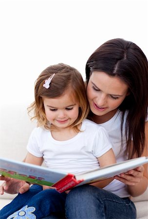 simsearch:400-05749644,k - Mother and daughter reading a book on sofa at home Stock Photo - Budget Royalty-Free & Subscription, Code: 400-05180190