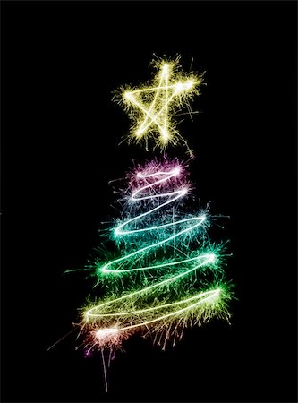 stockarch (artist) - A colourful christmas tree symbol drawn in sparkler trails Foto de stock - Royalty-Free Super Valor e Assinatura, Número: 400-05180864