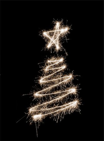stockarch (artist) - A christmas tree symbol drawn in sparkler trails Foto de stock - Royalty-Free Super Valor e Assinatura, Número: 400-05181549