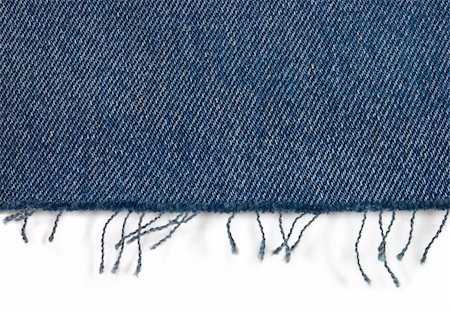 Edge of blue jeans fabric with fringe on white Stockbilder - Microstock & Abonnement, Bildnummer: 400-05182351