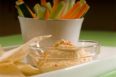 eating olive - middle eastern hummus dip on a glass bowl with homemade pita brad and raw vegetable Stock Photo - Budget Royalty-Free & Subscription, Code: 400-05183129
