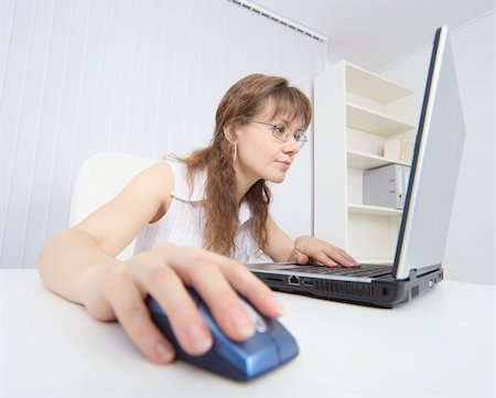 The amusing woman attentively studies the Internet by means of the laptop Stock Photo - Budget Royalty-Free & Subscription, Code: 400-05194037