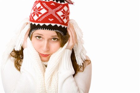 snow cosy - Young woman is freezing and wearing a cap and a scarf with hands in her face. Isolated on white. Stock Photo - Budget Royalty-Free & Subscription, Code: 400-05195704