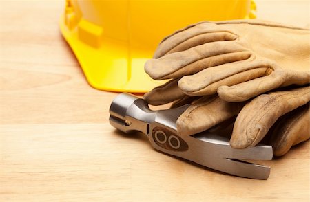 Yellow Hard Hat, Gloves and Hammer on Wood Surface. Stock Photo - Budget Royalty-Free & Subscription, Code: 400-05195820
