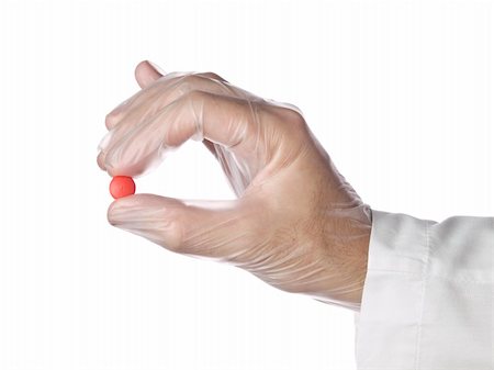 rubber nurse - A doctor holds a red pill with his latex gloves on. Isolated on white. Stock Photo - Budget Royalty-Free & Subscription, Code: 400-05195974