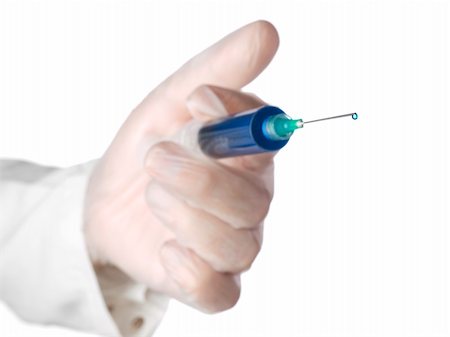 A doctor holds a syringe with a blue liquid. Selective focus on the drop. Stock Photo - Budget Royalty-Free & Subscription, Code: 400-05196006