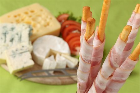 emmentaler cheese - Bacon wrapped grissini breadsticks and cheese board in background Stock Photo - Budget Royalty-Free & Subscription, Code: 400-05196501