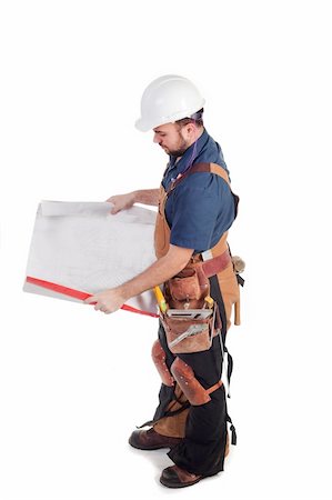 a construction worker looking at blue prints isolated Stock Photo - Budget Royalty-Free & Subscription, Code: 400-05196616