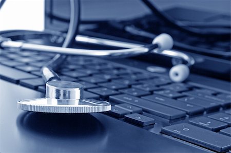 Doctor stethoscope on the laptop keyboard, image in blue tone Stock Photo - Budget Royalty-Free & Subscription, Code: 400-05197334
