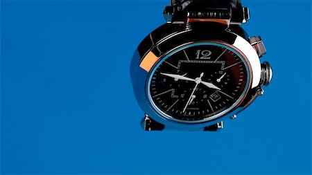 close-up of a wristwatch on a blue Stock Photo - Budget Royalty-Free & Subscription, Code: 400-05198252