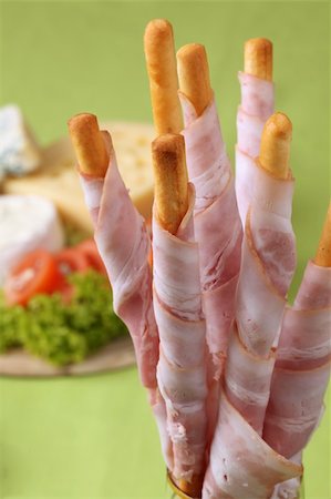 simsearch:400-06741554,k - Bacon wrapped grissini breadsticks and cheese board in background Foto de stock - Royalty-Free Super Valor e Assinatura, Número: 400-05198265