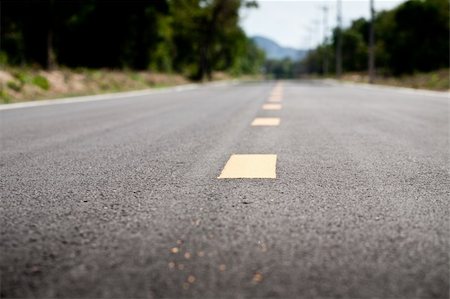 photo of lone tree in the plain - A long stretch of road with dividing line Stock Photo - Budget Royalty-Free & Subscription, Code: 400-05199961