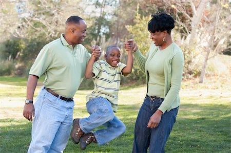 family grandparents parents african american - Playful African American Man, Woman and Child Having Fun in the Park. Stock Photo - Budget Royalty-Free & Subscription, Code: 400-05190196