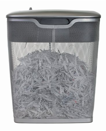 light duty paper shredder with metal wire basket filled with document shreddings, isolated on white Fotografie stock - Microstock e Abbonamento, Codice: 400-05190386