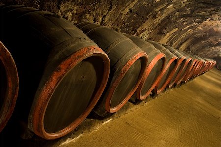simsearch:862-03354330,k - Row of Old wine barrels are stored in winery cellar near moss-grown wall Photographie de stock - Aubaine LD & Abonnement, Code: 400-05190469