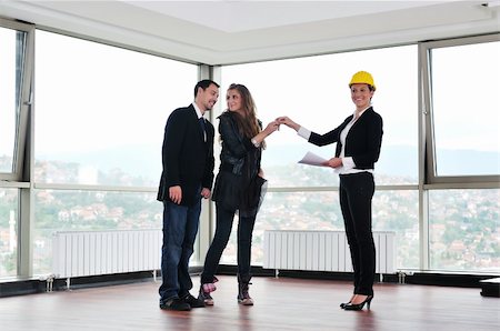 happy young couple buying new home with real estate agent and  looking big comfort bright apartment plans and taking key Stock Photo - Budget Royalty-Free & Subscription, Code: 400-05190616