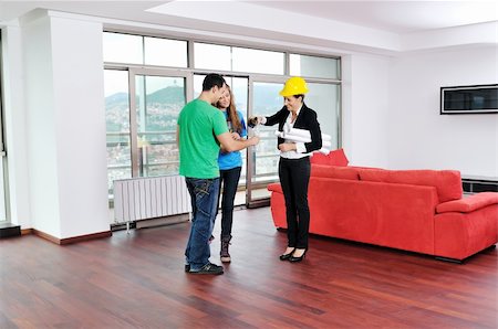 happy young couple buying new home with real estate agent and  looking big comfort bright apartment plans and taking key Stock Photo - Budget Royalty-Free & Subscription, Code: 400-05190620