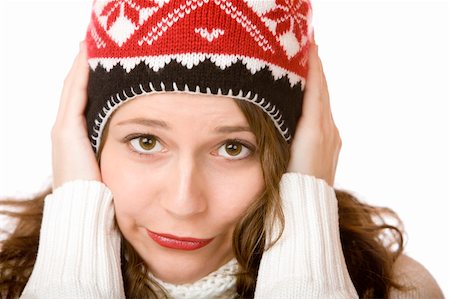 snow cosy - Young woman is freezing and wearing a cap and a scarf with hands in her face. Isolated on white. Stock Photo - Budget Royalty-Free & Subscription, Code: 400-05190960