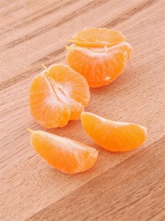 tangerine segments on wooden background Stock Photo - Budget Royalty-Free & Subscription, Code: 400-05191221