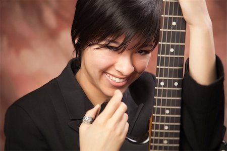 frente - Multiethnic Girl Poses with Her Electric Guitar. Stock Photo - Budget Royalty-Free & Subscription, Code: 400-05191507