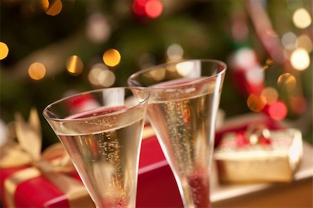 Sparkling Champagne Flutes and Gifts in Front of Decorations and Lights. Stock Photo - Budget Royalty-Free & Subscription, Code: 400-05191855