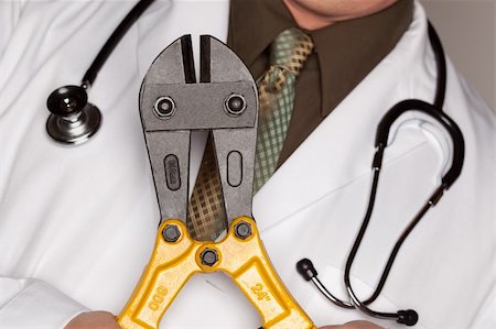 simsearch:400-05192324,k - Doctor with Stethoscope Holding A Pair of Cable Cutters. Stock Photo - Budget Royalty-Free & Subscription, Code: 400-05192292