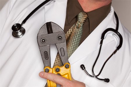 simsearch:400-05192324,k - Doctor with Stethoscope Holding A Pair of Cable Cutters. Stock Photo - Budget Royalty-Free & Subscription, Code: 400-05192293