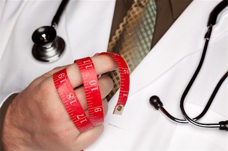 fat man exercising - Doctor with Stethoscope Holding Red Measuring Tape. Photographie de stock - Aubaine LD & Abonnement, Code: 400-05192346