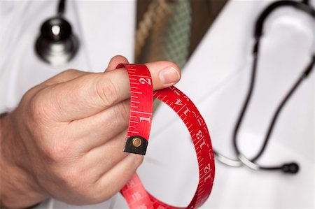 fat man exercising - Doctor with Stethoscope Holding Red Measuring Tape. Photographie de stock - Aubaine LD & Abonnement, Code: 400-05192348