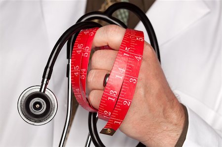 fat man exercising - Doctor with Stethoscope Holding Red Measuring Tape. Photographie de stock - Aubaine LD & Abonnement, Code: 400-05192351