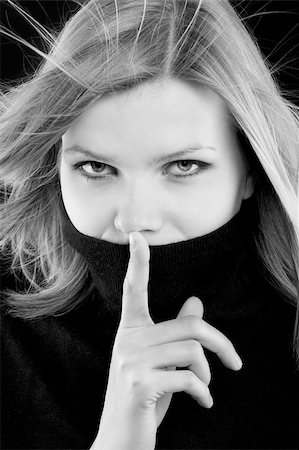 simsearch:400-06364563,k - young beautiful blonde girl in a black turtleneck is requesting silence. black and white image Stock Photo - Budget Royalty-Free & Subscription, Code: 400-05192628