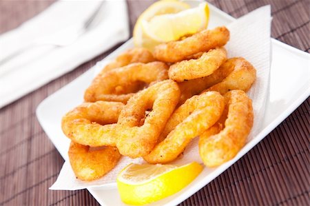 salt coating - plate of tasty fried calamari with lemon Stock Photo - Budget Royalty-Free & Subscription, Code: 400-05193222