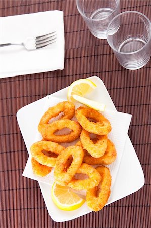 salt coating - plate of tasty fried calamari with lemon Stock Photo - Budget Royalty-Free & Subscription, Code: 400-05193223