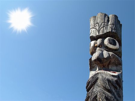 excitator (artist) - Wooden idol on the background of blue sky. A Jangseung (village guardian) is a Korean totem pole, to scare away demons. Foto de stock - Super Valor sin royalties y Suscripción, Código: 400-05193354