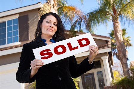 Happy Attractive Hispanic Woman Holding Sold Sign In Front of House. Stock Photo - Budget Royalty-Free & Subscription, Code: 400-05193518