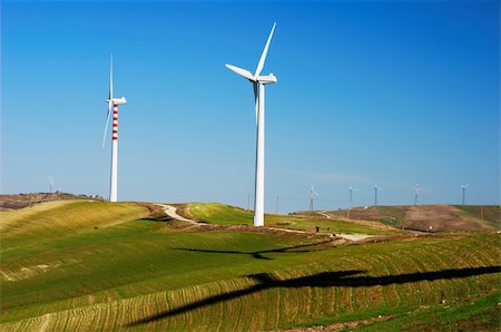 Vertical axis wind turbines and shadows on top of a hill Foto de stock - Super Valor sin royalties y Suscripción, Código: 400-05193545