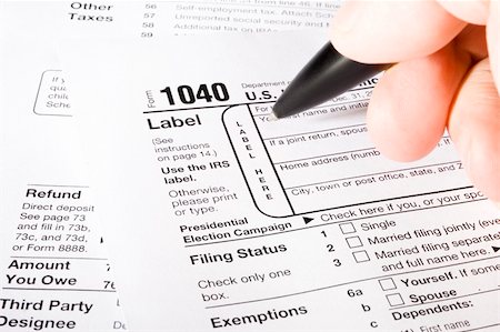simsearch:400-05339747,k - Stock image of man filling out 1040 Tax form Stock Photo - Budget Royalty-Free & Subscription, Code: 400-05193788