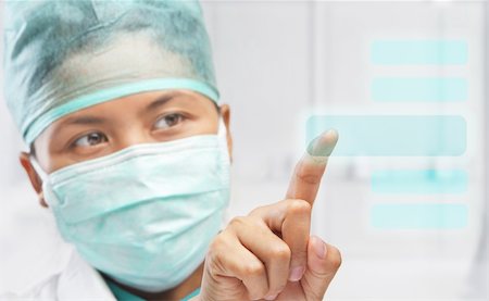 surgeon access - female medical worker or reseacher or scientist touching virtual button panel Stock Photo - Budget Royalty-Free & Subscription, Code: 400-05193851