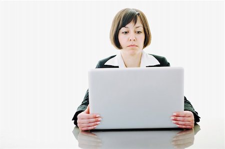 one young business woman isolated on white working on laptop computer Stock Photo - Budget Royalty-Free & Subscription, Code: 400-05204466