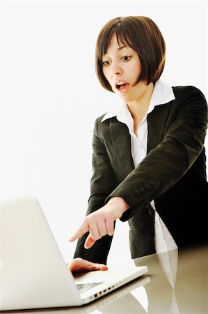 simsearch:400-05209692,k - one young business woman isolated on white working on laptop computer Stock Photo - Budget Royalty-Free & Subscription, Code: 400-05204472
